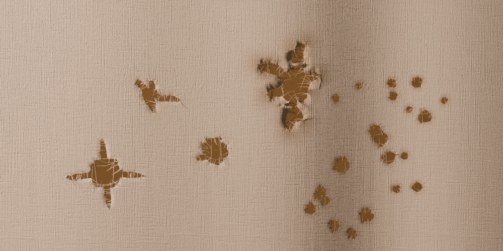Clicks on a linen sheet in front of a warm wall: bullet holes, shrapnel, buckshot and an arrow hole appear