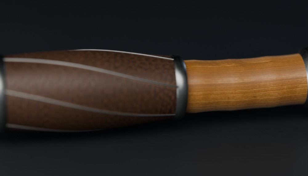 Close-up: the leather-bound grip and pewter collar of Erudite