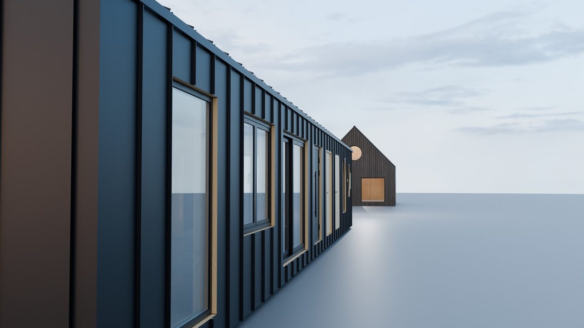 A long cabin clad in standing seam siding, seen along its wall