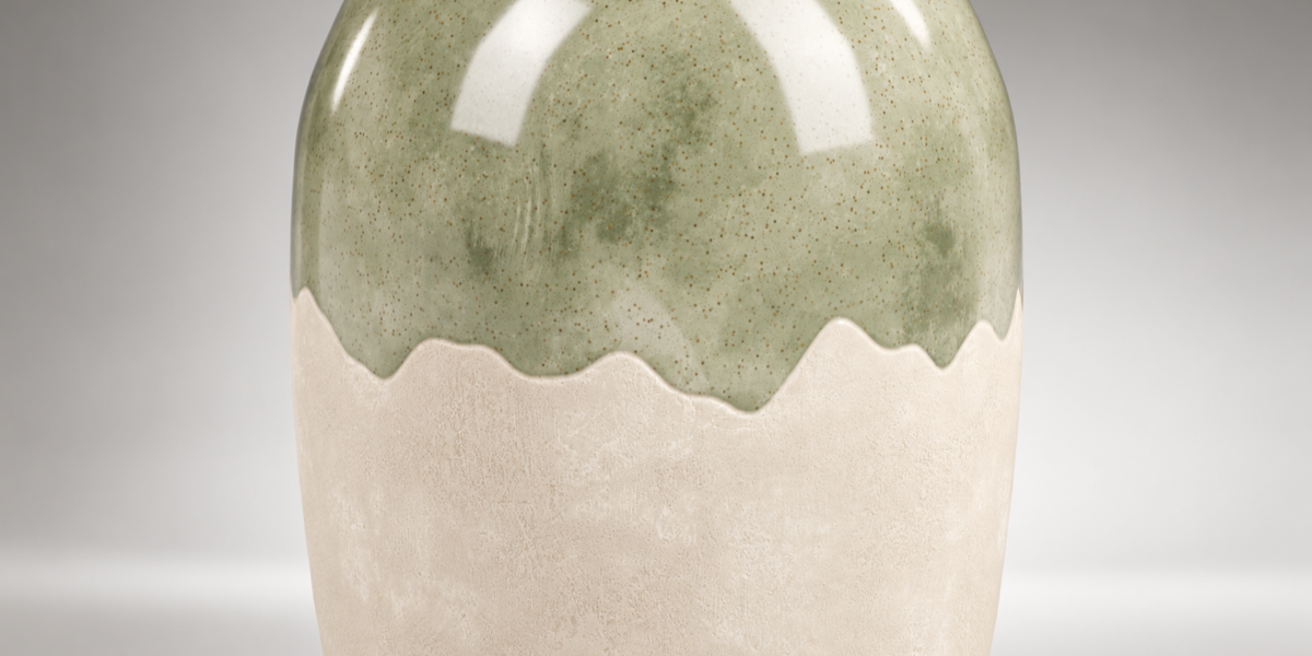 Close view of mottled green glaze meeting cream ceramic