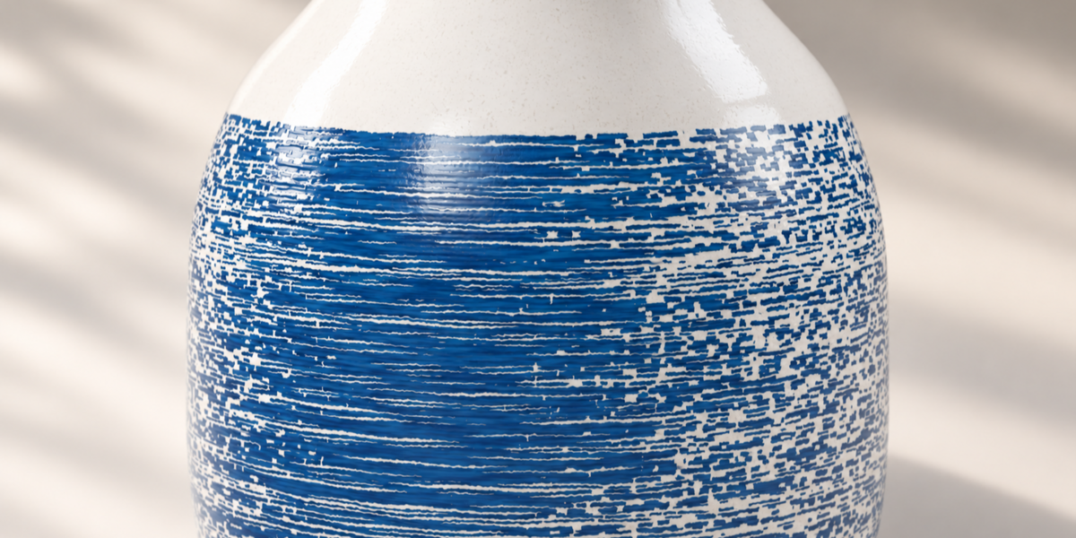Close view of blue brushstroke decoration on white ceramic